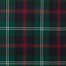 The Laird Hooded Scarf Cape draped elegantly over a chair, highlighting its fashionable design and customizable tartan options.