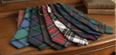 Gents Wool Tartan Tie - Best Seller displayed in various tartan designs, emphasizing versatility and heritage.
