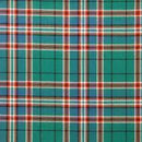 Tartan Poncho - Reiver, worn elegantly at a festival, demonstrating versatility and chic style.