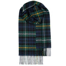 A model wearing the Bowhill Standard Tartan Lambswool Scarf in a cozy winter setting, showcasing the scarf's warmth and classic appeal.