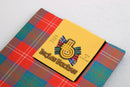 Chisholm Ancient Wool Tartan scarf draped elegantly, showcasing its vibrant pattern and soft material.