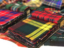 Lightweight Swatches from The Kiltmakery showcasing a variety of tartan fabrics in vibrant colors and patterns, perfect for kilt and skirt crafting.