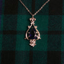 Close-up view of the elegant Teardrop Pendant by Art Pewter, showcasing its stunning cut glass colored stone and Victorian-inspired design.