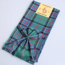Wool Mini Sash in Sinclair Hunting Ancient Tartan draped stylishly, showcasing its vibrant colors and traditional Scottish design, perfect for adding a touch of tartan to any outfit.