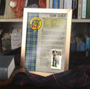 Leslie Clan History Print displayed in a stylish A4 frame, showcasing the clan crest and tartan on high quality parchment style paper - Choose Framed or Unframed from ScotClans.