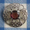 Elegant Brooch Celtic Circle Dark Stone featuring intricate Celtic design with a dark stone centerpiece, perfect for adding sophistication to any outfit.
