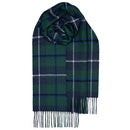 Person elegantly draped in a Bowhill Standard Tartan Lambswool Scarf, emphasizing its versatility as a winter accessory.