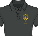 Elliot Clan Crest Embroidered Polo displayed on a model in a sunny outdoor setting, showcasing the stylish flat knit collar and two button placket.