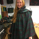 Model wearing The Laird Hooded Scarf Cape with an attached hood, demonstrating its versatility and elegance for outdoor adventures.