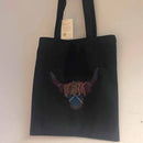 Highland Cow Tote Bag in Scotland 2000 Tartan featuring a vibrant tartan background and stylish Highland Cow design.