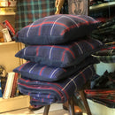 American National Fleece lined Tartan Throw beautifully draped on a cozy sofa, showcasing its elegant tartan design and soft fleece backing.