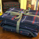 Stylish display of the American National Fleece lined Tartan Throw and Cushion Cover Set, perfect for enhancing home decor with warmth and elegance.